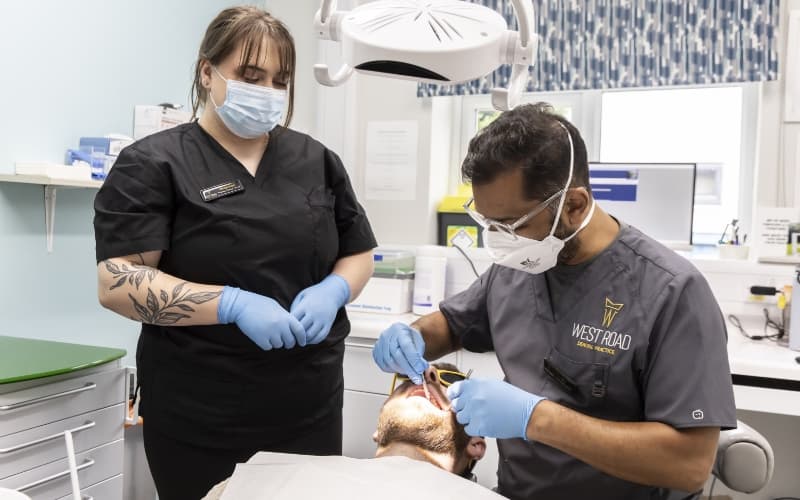 Two clinicians in the surgery preparing for root canal treatment