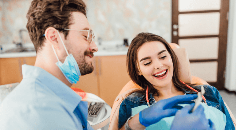 A dentist and patient in the surgery following teeth whitening treatment
