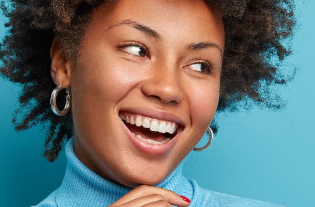 A woman laughing, showing healthy natural teeth