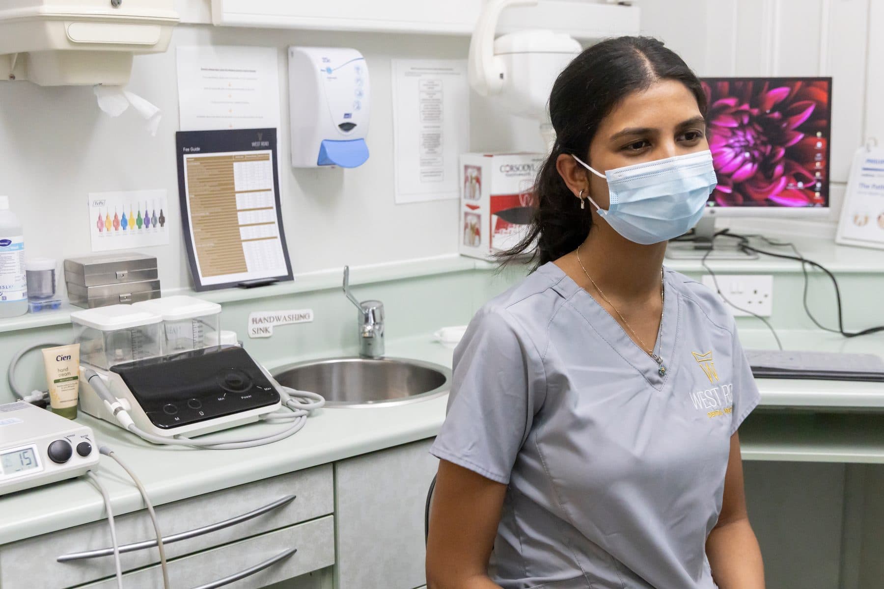 A West Road Dental clinician in the surgery, with the treatment chair and equipment behind