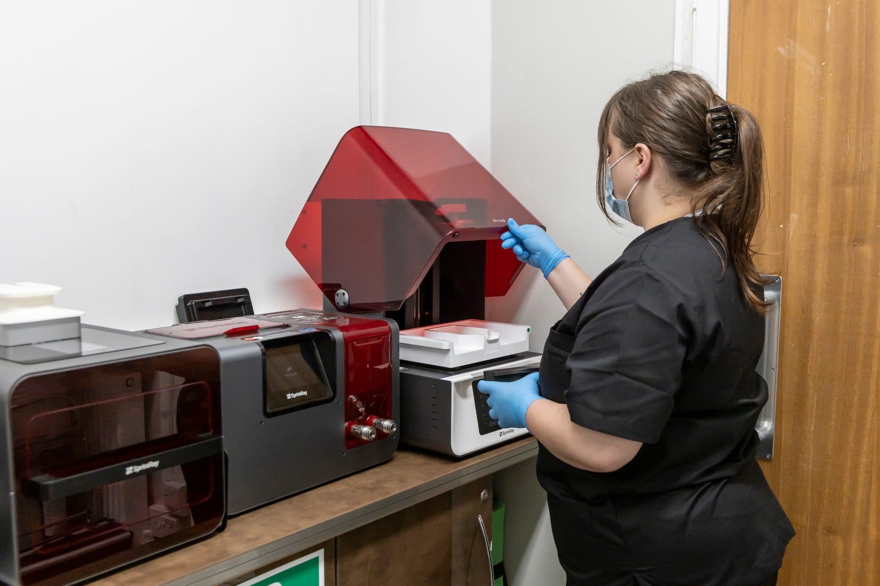 A nurse operating the practice’s sterilisation equipment in the decontamination room