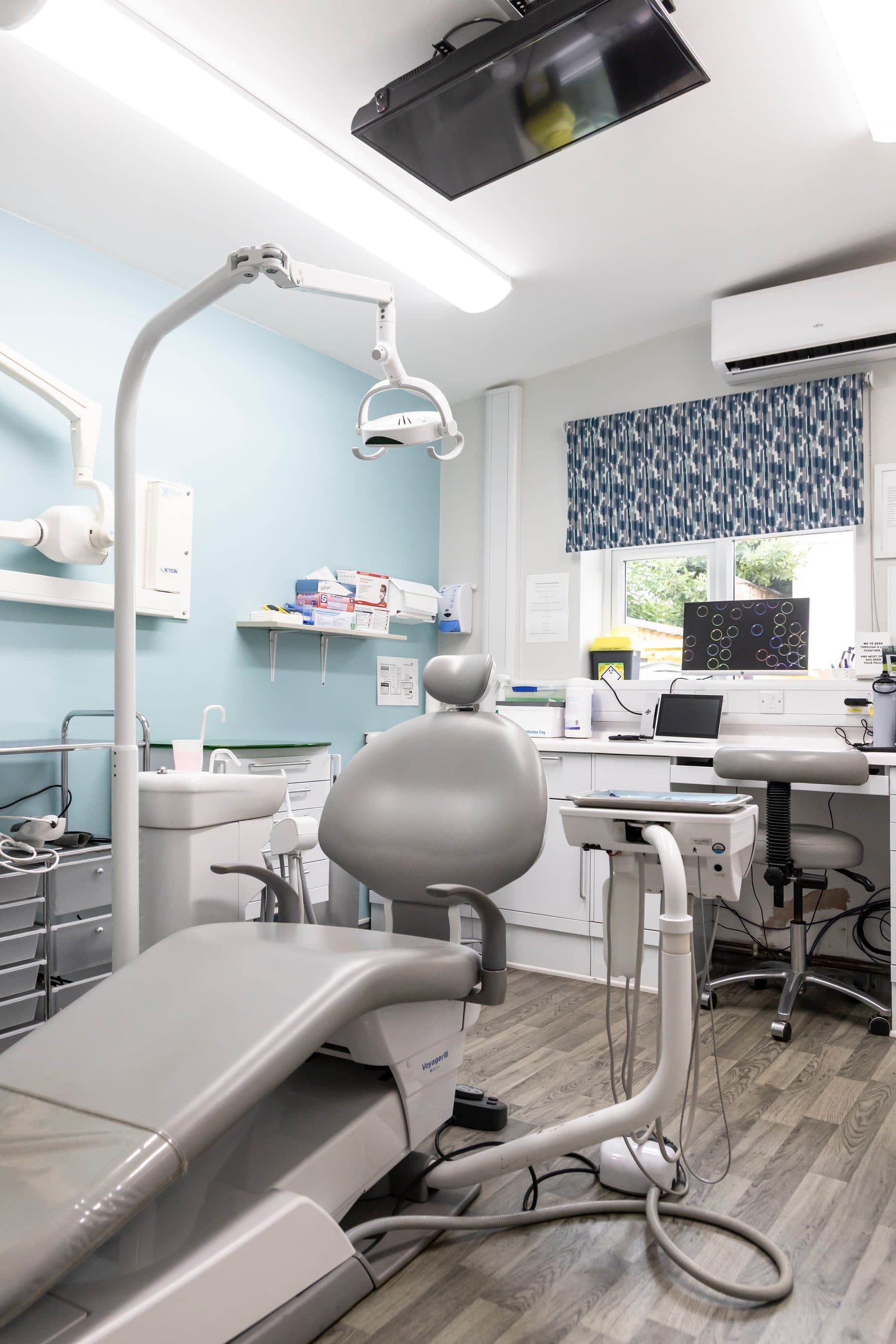 A bright treatment room at the Oakham practice with a window and dental chair