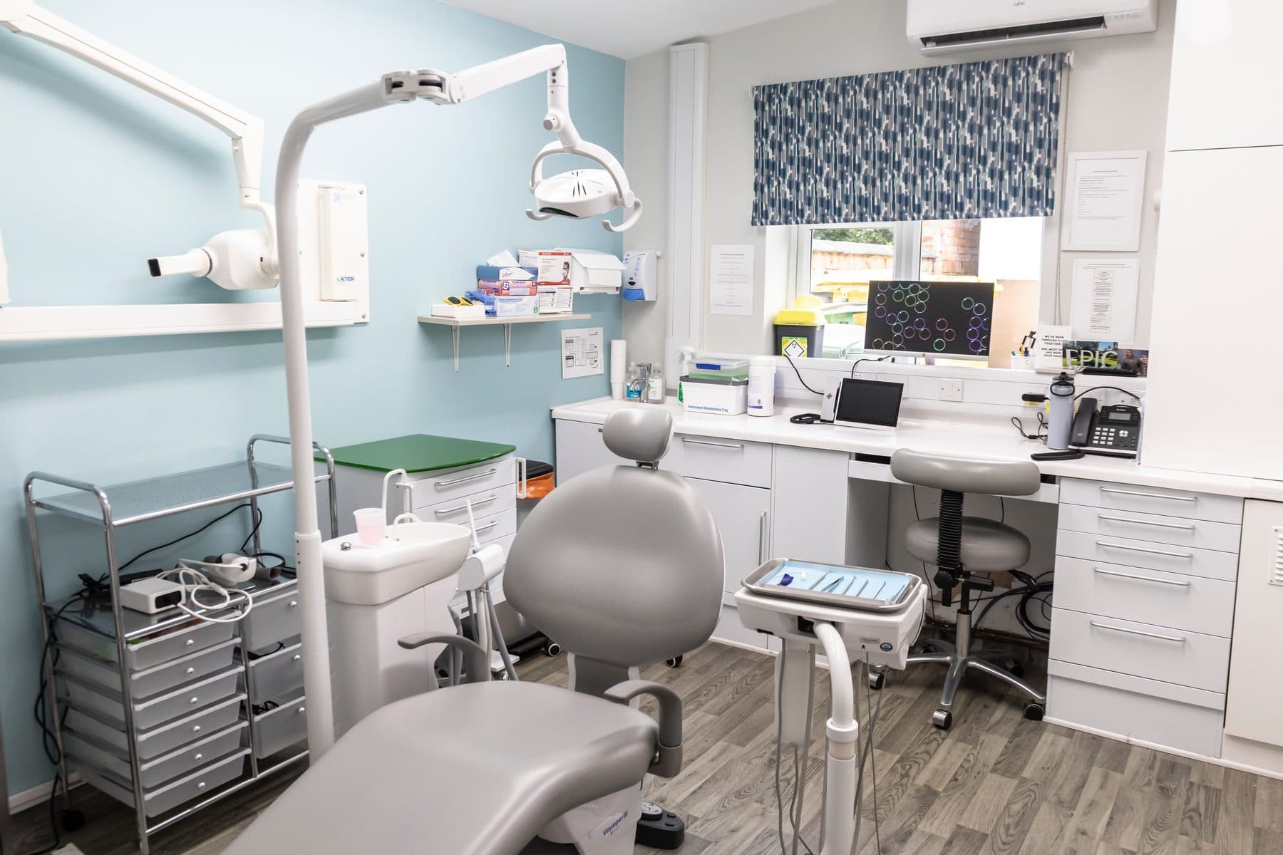 A treatment room at West Road Dental Practice, with chair, overhead light and worktops